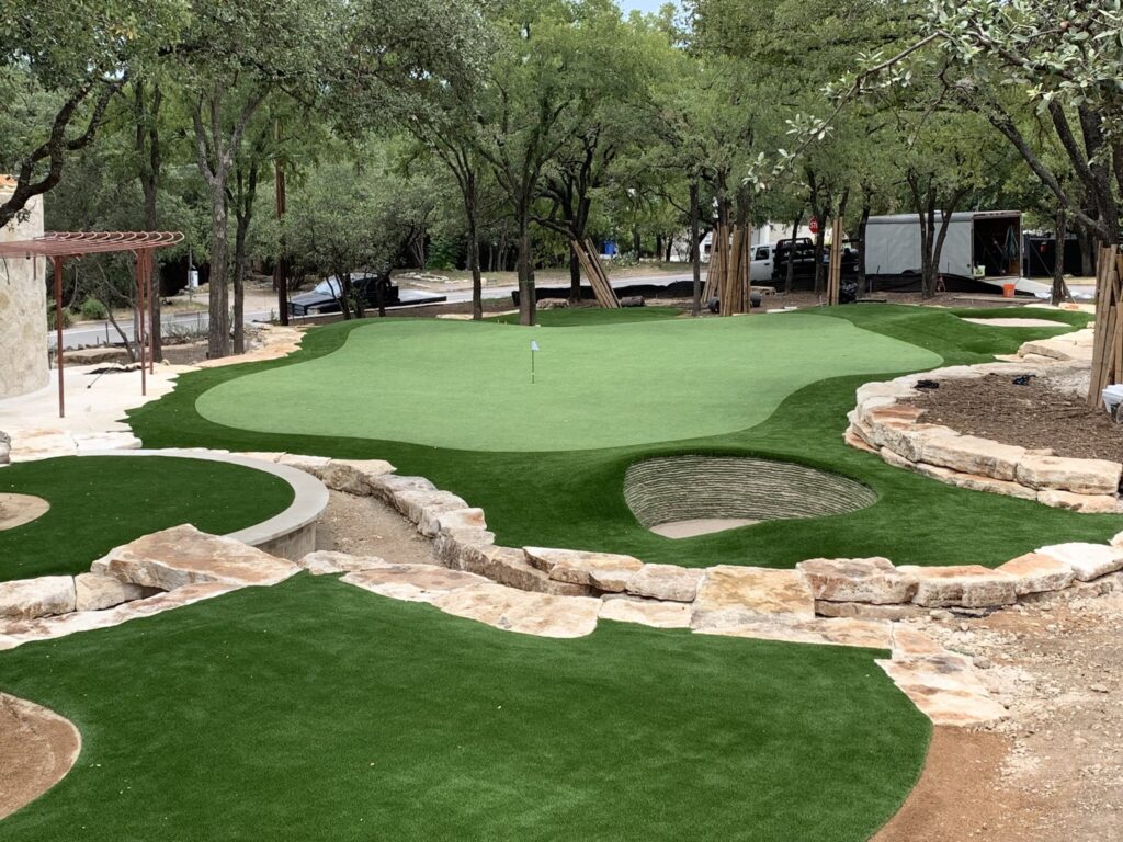 installation of backyard putting green with stacked sod bunker